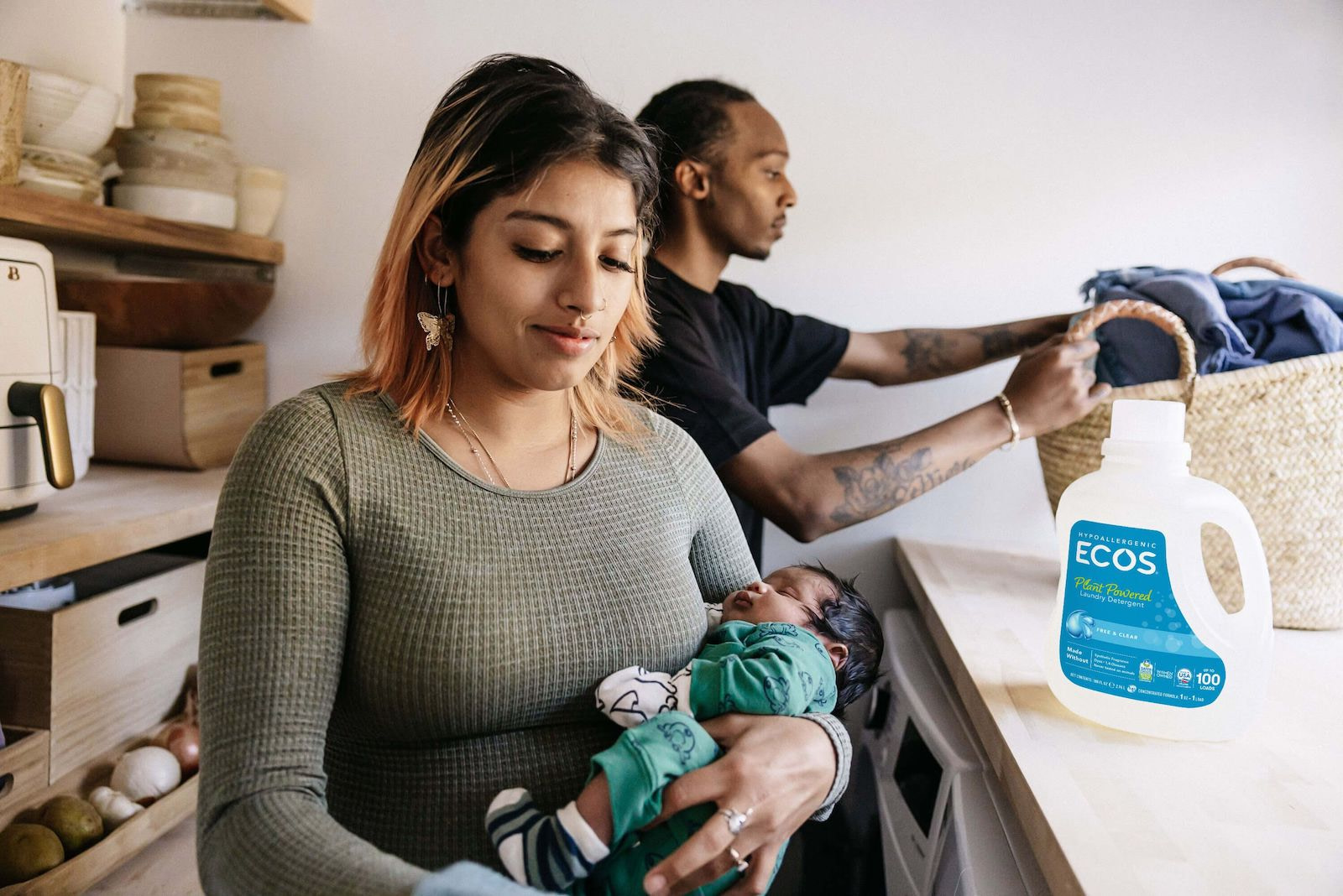 Mother Holding Newborn Father Washing Baby Clothes